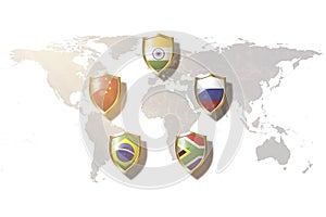 Brics Brazil, Russia, India, China, and South Africa countries flags in golden shield on world map background