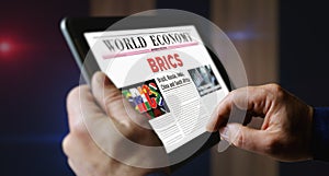 BRICS economy association newspaper on mobile tablet screen