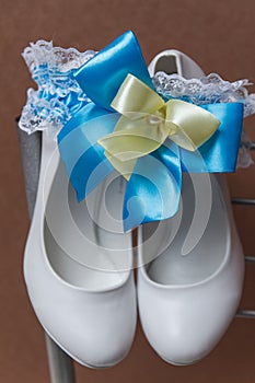 Bridal accessories on a white chair with flowers, photo
