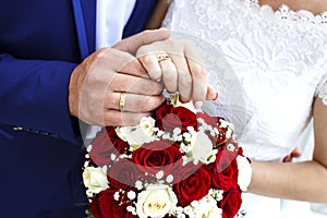 Bridal bouquet. Bride and groom holding hands