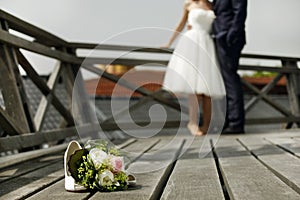 Bridal bouquet with bride and groom photo