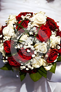 Bridal bouquet. The bride`s . Beautiful of white flowers and greenery, decorated with silk ribbon, lies on vintage