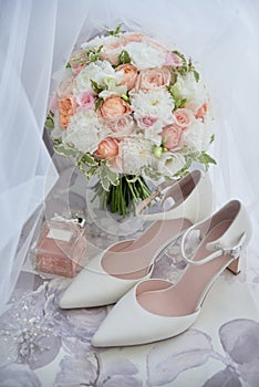 Bridal bouquet, bride shoes and earings on chair, copy space. Luxury wedding accessories and jewelry. Wedding concept.