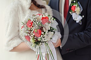 Bridal bouquet close up in the hands of the bride and groom