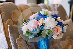 Bridal bouquet with creamy roses and peonies and blue hydrangeas. Wedding morning. Close-up