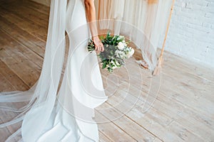 Bridal bouquet of fresh flowers in hands of bride