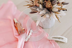 Bridal bouquet and hair accessories. Close-up wedding details. Beauty  fashion blog concept. Stylish feminine accessories flatlay