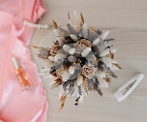 Bridal bouquet and hair accessories. Close-up wedding details. Beauty  fashion blog concept. Stylish feminine accessories flatlay
