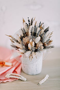 Bridal bouquet and hair accessories. Close-up wedding details. Beauty  fashion blog concept. Stylish feminine accessories flatlay