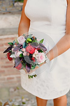 Bridal bouquet held by her with her hands at her wedding