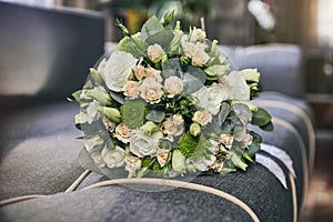 Bridal bouquet lie on a sofa. Wedding acsessories