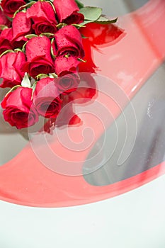 Bridal bouquet. Reflection of a wedding bouquet in glass, mirror. Flowers lie on the table. A flowers arrangement of rose rosettes