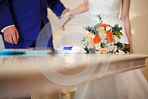 Bridal bouquet on table during the ceremony of marriage registration. Copy space.