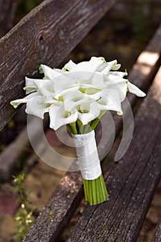 Bridal bouquet of white calla lily. Wedding minimalist flowers. Wedding bouquet