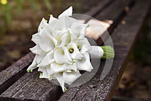 Bridal bouquet of white calla lily. Wedding minimalist flowers. Wedding bouquet