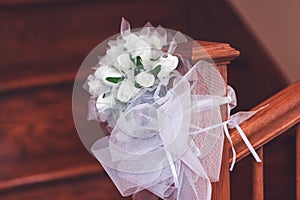 Bridal bouquet of white roses in bright colors on the stair rail