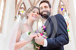 Bridal couple in church having wedding