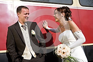 Bridal couple leant on wagon