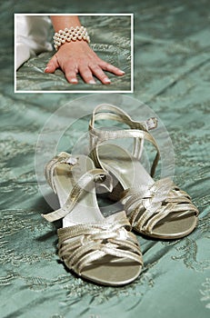 Bridal hand on the bed and wedding shoes