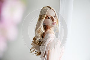 Bridal makeup concept. Gorgeous young woman with long blonde hair