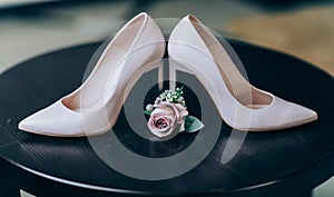 Bridal morning details composition. Wedding bouquet of pink flowers, boutonniere and leather shoes