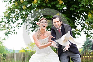 Bridal pair with flying white doves