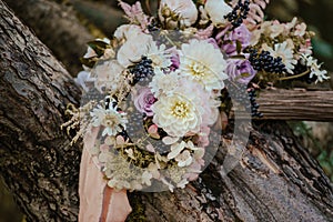 Bridal rustic bouquet over wooden background.