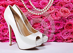 Bridal Shoes and Roses. White Heels over Hot Pink Flowers