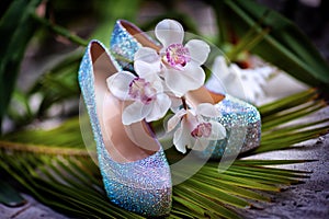 Bridal wedding shoes with diamante near the starfish, white flowers