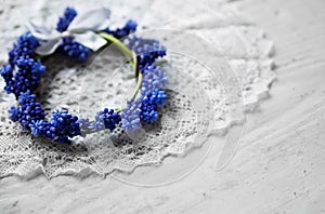 Bridal wreath lying on a lace napkin. Wedding accessories. Blue flowers.