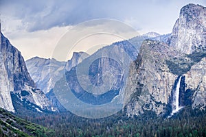 Bridalveil Falls and Yosemite Valley as seen from Tunnel View vista point on a rainy summer day, Yosemite National Park, photo
