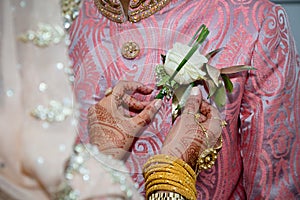 Bride adjusting buttonhole