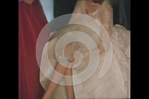 Bride adjusting garter on her leg