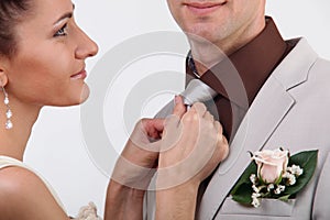 Bride adjusting groom's tie