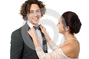 Bride adjusting her man's bow tie