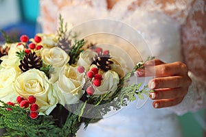 The bride adjusts the wedding bouquet