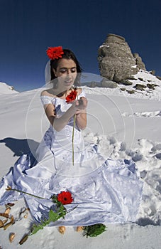 Bride adorned with crimson flowers.