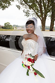 Bride african american woman in weddin day with white limousine car