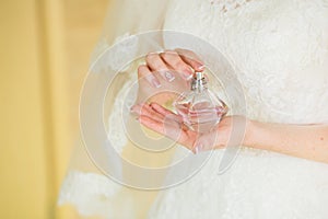 Bride applying perfume