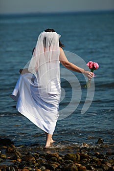 Bride barefoot in water