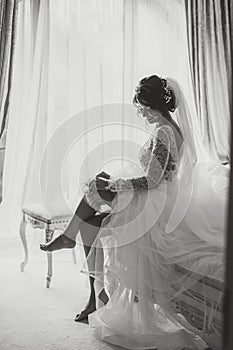 Bride in a beautiful dress, model posing, portrait photo, bride wearing a garter.