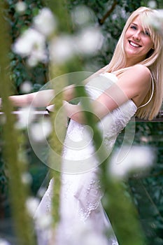 Bride behind flowers