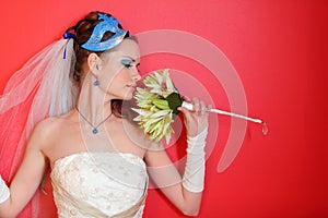 Bride with blue makeup and mask in hairdo
