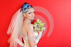 Bride with blue mask in hairdo holds bouquet