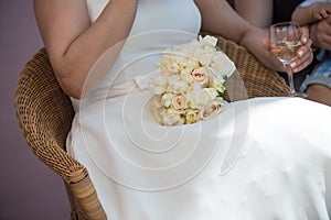 Bride with the bouquet on her lap