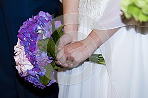 The bride bouquet and her new ring, wedding detail 