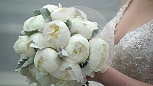 Bride with bouquet of peonies