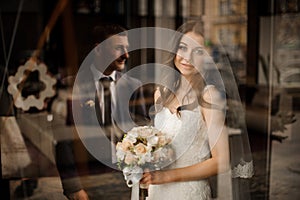 Bride with bouquet of roses smiling and waiting for groom