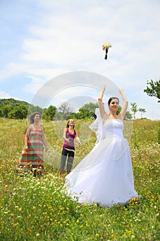 Bride bouquet toss to bachlorettes photo