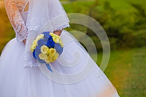 Bride with a bouquet during a wedding photo shoot in nature